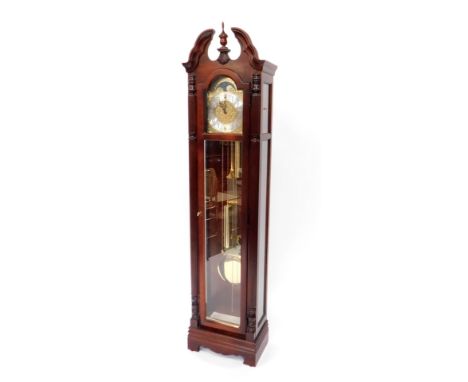 Howard Miller. A mahogany cased longcase clock, the brake arch dial with silvered chapter ring bearing Arabic numerals, three