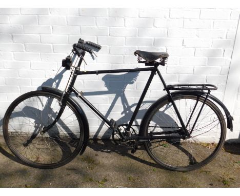 A vintage gentleman's bicycle, with a Brooks &amp; Company Pliflex 205 seat, and an Ever Ready bicycle lamp.