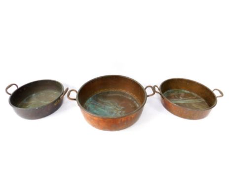 A Victorian copper jam pan, handle bracket stamped no.18, 62cm W, and two further jam pans, one stamped no.14, 46cm W. (3)