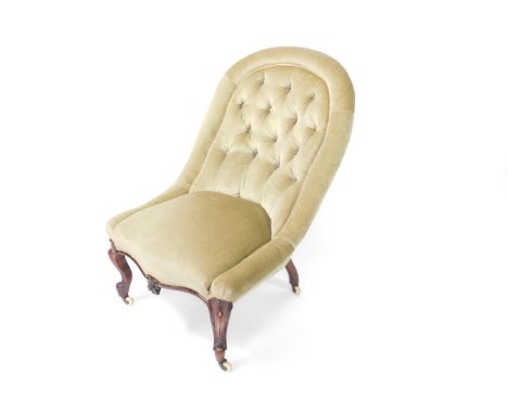 A Victorian mahogany spoonback nursing chair, with button back and overstuffed green draylon upholstery, raised on cabriole l