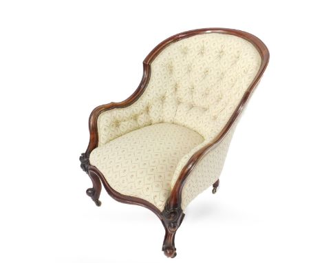 A Victorian walnut spoon back ladies armchair, with profile moulded show frame, serpentine seat, scroll legs with brass cup c