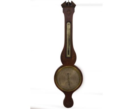 An early 19thC mahogany wheel barometer, with broken arch pediment, floral marquetry roundel over a silvered thermometer, ova