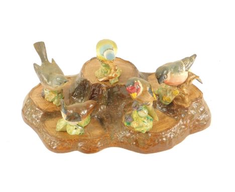 A Beswick pottery tree trunk display stand, together with five Beswick birds. (6)