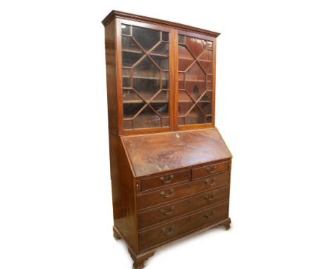 A George III mahogany bureau bookcase, with moulded top over two astragal glazed doors revealing adjustable shelves, over a f