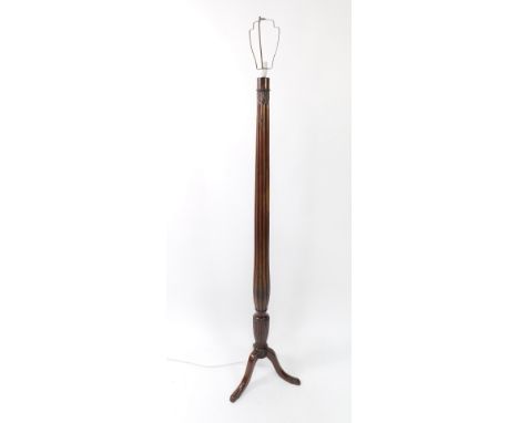An early 20thC mahogany standard lamp, with a fluted and leaf carved column, raised on cabriole legs.