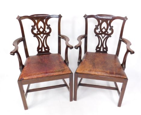 A pair of late 19thC mahogany carver chairs in the Chippendale manner, with scrolling ribbon backs and drop in red leather se