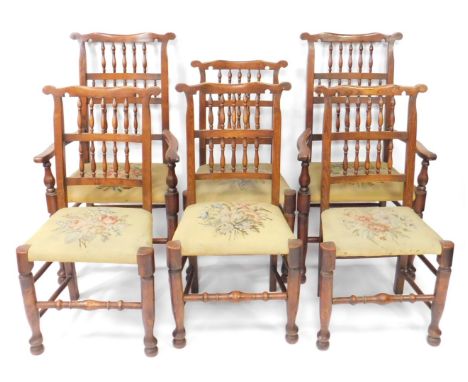 A set of six early 19thC elm gate back dining chairs, including two carvers, with shaped arms, floral wool work overstuffed s