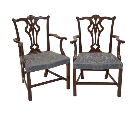 A set of six Chippendale design mahogany dining chairs, including two carvers, with pierced vase splats and overstuffed blue 