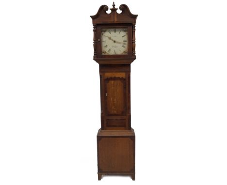 An early 19thC mahogany longcase clock, with moulded swan neck and turned pillared hood, with mahogany crossbanded canted tru