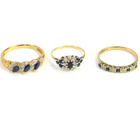 A 9ct gold sapphire and diamond set ring, size R, a sapphire and diamond flower head ring, set in yellow metal, size J, and a