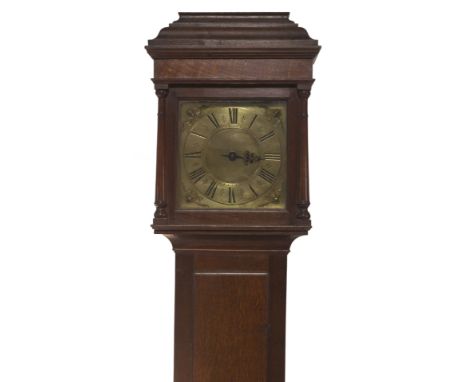 A 18thC oak longcase clock, with caddy hood having medullary ray decorated frieze over quarter inset columns, having plain fu