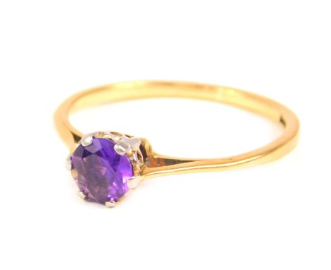 An amethyst solitaire ring, with round brilliant cut amethyst 4.8mm x 2.6mm, in a raised claw setting, with pierced V shaped 