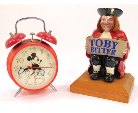 A seated Toby Bitter advertising figure, raised on a canted wooden base, 19cm H, together with a Disney Apollo Mickey Mouse a