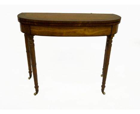 A George III satinwood card table, with rounded rectangular rosewood crossbanded folding top, frieze with ebony stringing on 