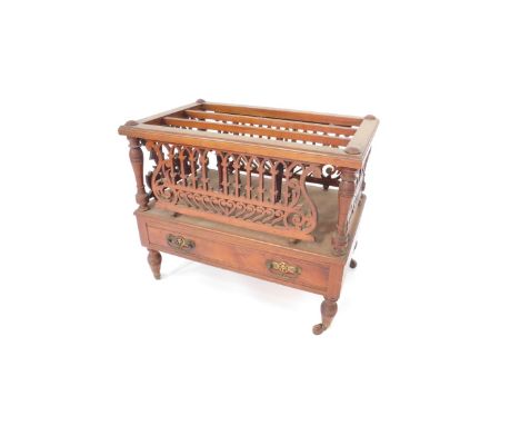A Victorian walnut Canterbury, with turned and extended lyre fret work panels, over a single drawer with brass loop handles, 
