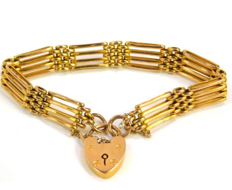 A 9ct gold four bar gate bracelet, on a heart shaped padlock clasp with safety chain as fitted, 12.5g.