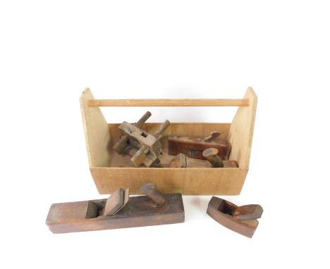 A carpenter's tool caddy containing molding planes and a brace, 52cm W.