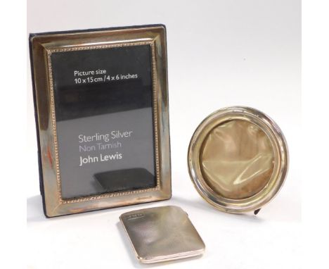 A silver strut photograph frame, Sheffield 2005, aperture 14.5cm x 9.5cm. George V silver strut photograph frame, oak backed,