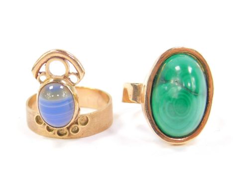 A 9ct gold and malachite ring, high cabachon set, size S, and a 9ct gold and banded agate set ring, size Q, 12.4g. (2)