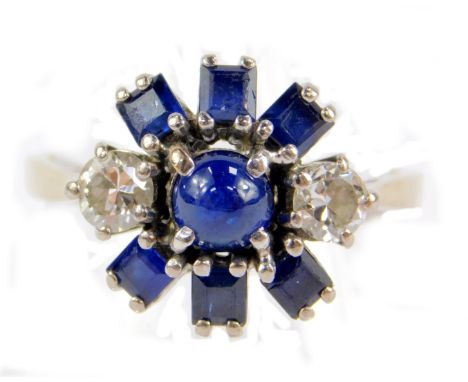 A sapphire and diamond star burst cluster ring, set with a pair of brilliant cut diamonds single cabachon and six square cut 