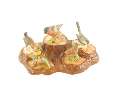 A Beswick pottery tree trunk stand, together with two Beswick birds and three Goebel birds. (6)