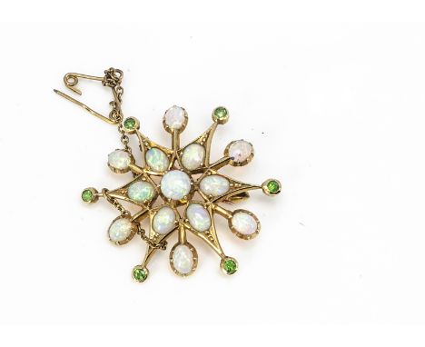 An Edwardian yellow metal precious opal and demantoid garnet star brooch, the twelve pointed star alternately set with round 