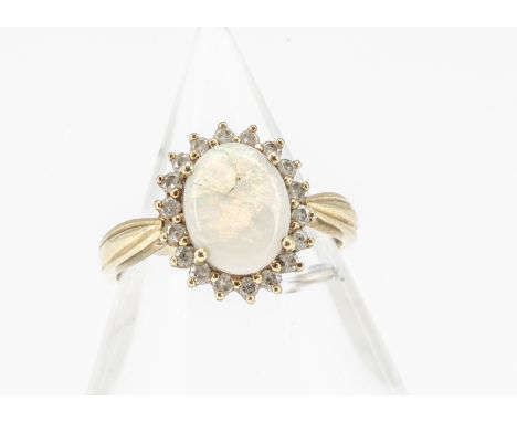 An 18ct gold opal and diamond cluster ring, the oval opal heavily af, surrounded by a bezel of small brilliant cut diamonds, 