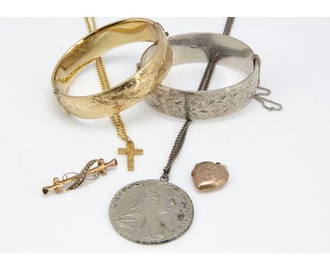 A silver hinged bangle with engraved design, together with a gilt metal example, a Thaler coin pendant, gold bar brooch with 