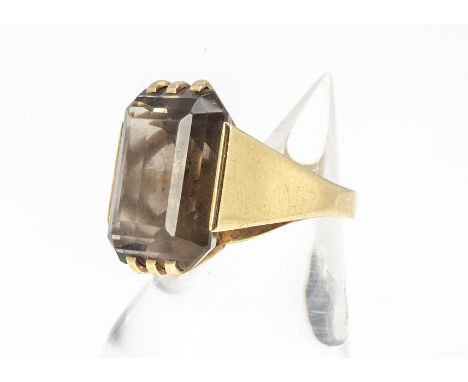 A continental 18ct gold smoky quartz cocktail ring, marked Justa, the baguette cut smoky quartz in claw setting with tapered 