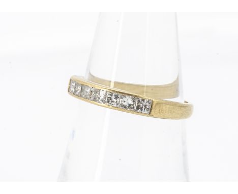 A channel set princess cut seven stone 18ct gold dress ring, ring size M, 2.7g