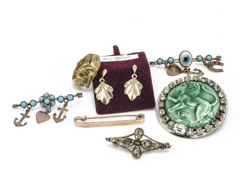 A gilt metal erotic ring of lovers entwined, ring size M, together with an evil eye faith, hope and charity bar brooch, anoth