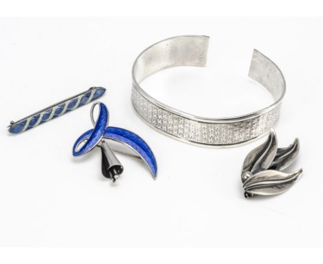 Three silver Scandinavian brooches, including an N.E From leaf brooch, a silver and enamel floral brooch, a blue and white en