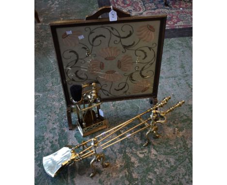 A brass three piece companion set; a pair of andirons; firescreen; etc