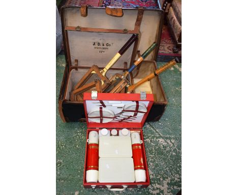 An early 20th century canvas and leather bound trunk; another travel case; a Sirram picnic set; wooden tennis rackets and bra