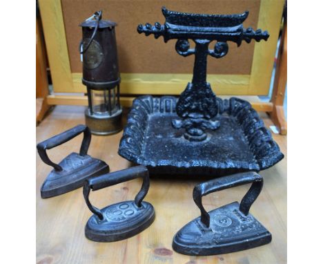 A cast iron boot scraper; an Eccles miner's lamp, no 67; flat irons (5)