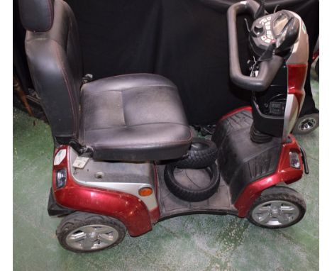 A Kymco 1C mobility scooter, two spare tyres