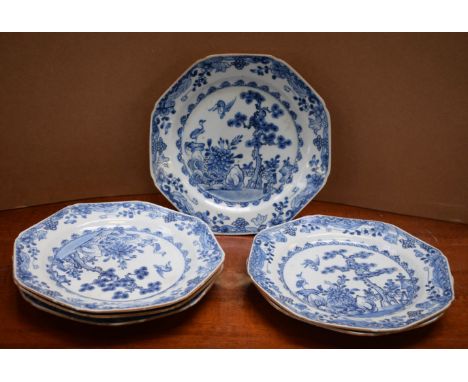 A set of six Chinese octagonal plates, painted in underglaze blue with storks, pine tree and fence, elaborate flower and scro