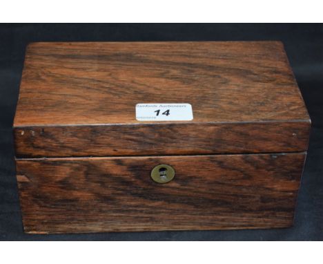 An early 20th century rosewood rectangular tea caddy, hinged cover enclosing a pair of lidded compartments, 20cm wide