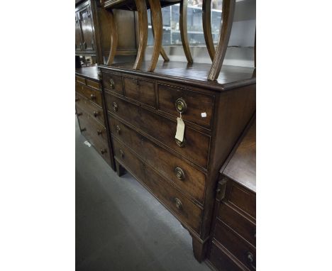GEORGE III MAHOGANY CHEST OF THREE SHORT AND THREE GRADUATED LONG DRAWERS, ON SPLAY BRACKET FEET AND HAVING BRASS RING HANDLE