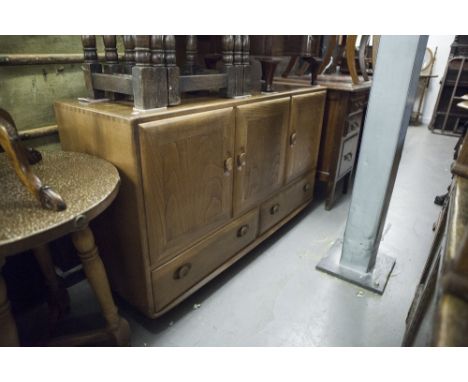 SMALL ERCOL LIGHT ELMWOOD SIDEBOARD WITH THREE PANEL DOORS AND TWO BASE DRAWERS ALL WITH RECESSED OVAL KNOB HANDLES 