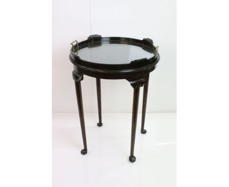 Edwardian Mahogany Circular Table with lift-out glass bottom tray top with twin brass handles, raised on turned tapering legs