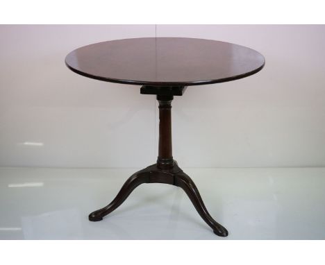 George III Mahogany Tilt Top Supper Table, the circular one piece top with bird cage action, raised on gun barrel pedestal an