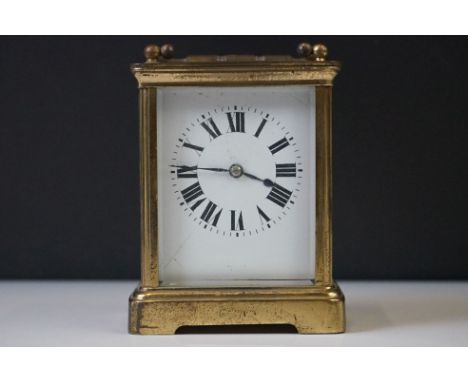 A French carriage clock with bevelled glass panels and white enamel dial, complete with key. 