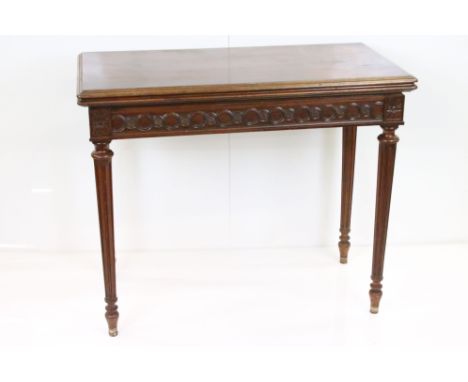 Mahogany Card Table in the Regency manner, the rectangular fold-over top opening to a green baise playing surface, carved fri