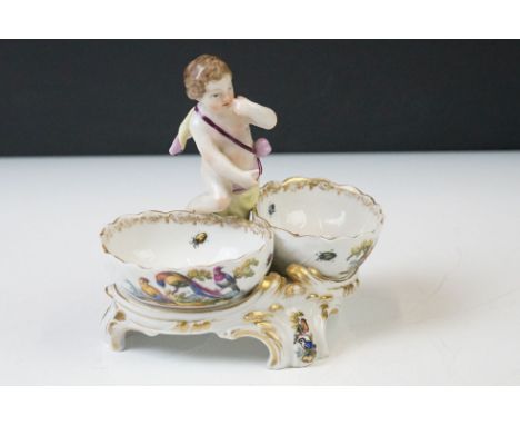 19th Century KPM Berlin Porcelain Table Salt in the form of a putti flanked by two bowls with hand painted ornithological dec