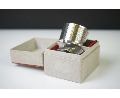 A pair of fully hallmarked sterling silver napkin rings with engine turned decoration and original retailers box, assay marke