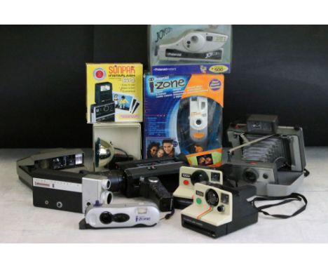 A collection of Polaroid cameras including a Polaroid SX-70 and two cine cameras including Canon. 