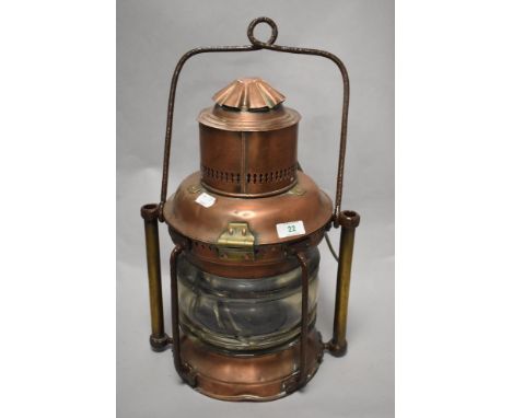 A 19th Century copper and brass ship's masthead lantern, with painted turned carrying handle, and measuring 50cm tall