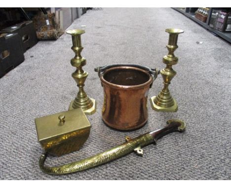 Two brass candlesticks, a hammered brass trinket dish, a copper and brass handled cooking pot and a dagger with embossed bras