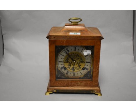 An early 20th Century bracket clock, having a two train movement, and housed within a walnut case with applied presentation p